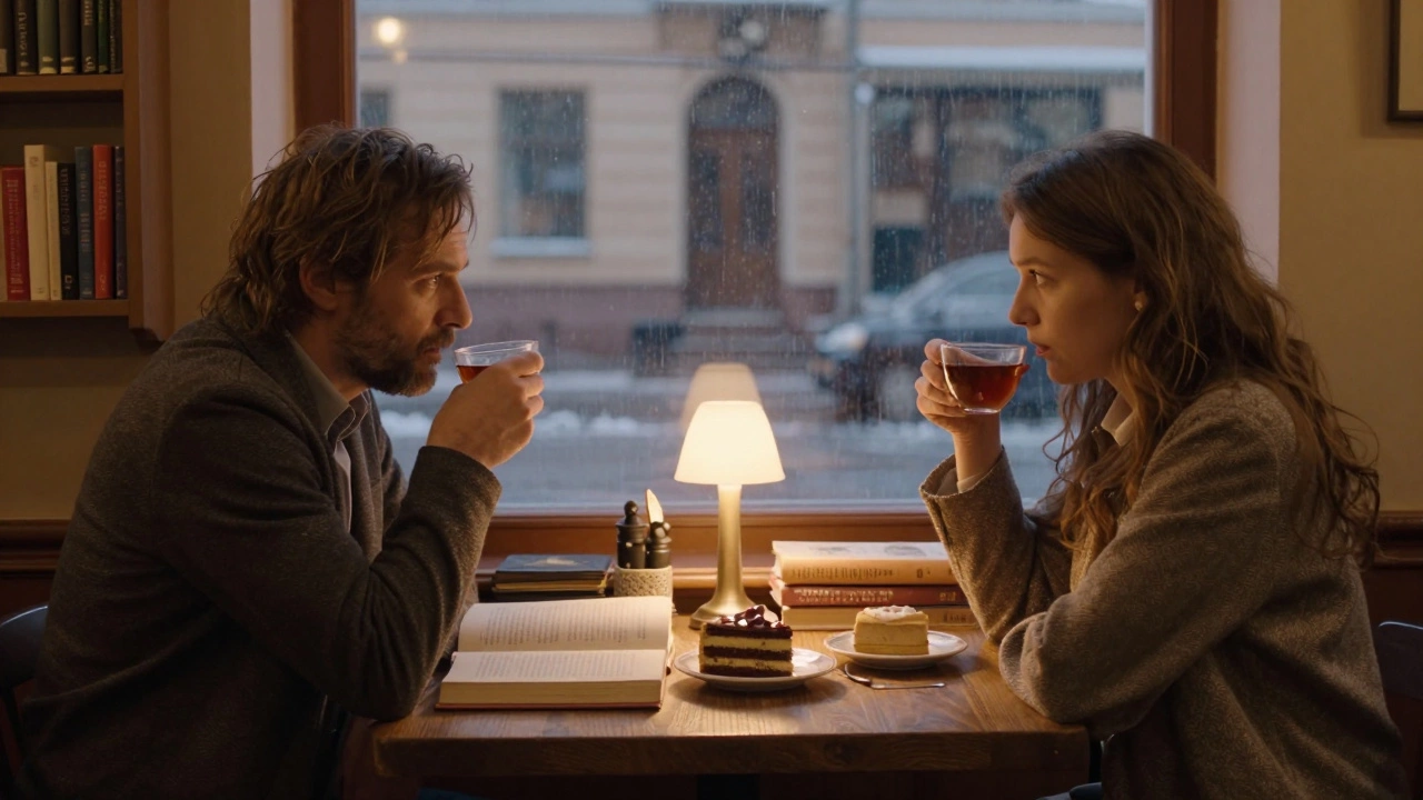 Two people silently sharing tea in a St. Petersburg café, books and cake between them.